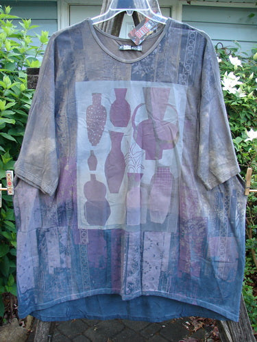 Barclay NWT Tournesol Tunic Fancy Vase Lunar Eclipse OSFA features a tunic-length design with drop shoulders, loose three-quarter sleeves, and a rounded neckline, highlighted by a mottled earthen backdrop.