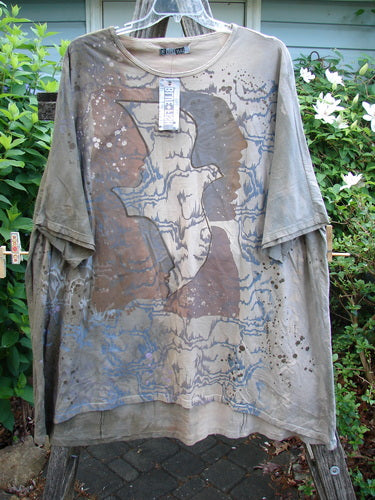 Barclay NWT Art Tee Mountain Dove Cafe Au Lait OSFA features a tunic length, drop shoulders, loose three-quarter sleeves, rounded neckline, and a varying hemline, showcasing artistic design.
