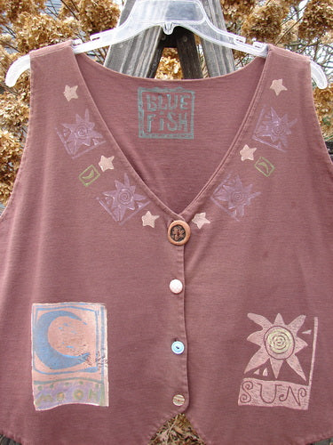 1989 Folk Vest with Sun and Moon design, Paprika color, in Perfect One Size Fits All Condition. Double Layered Cotton, Mix and Match Buttons, Tuxedo Tails, V Shaped Neckline. Vintage Collectible from Blue Fish History. Bust 50, Waist 48, Front/Back Lengths 20, Side Lengths 26.
