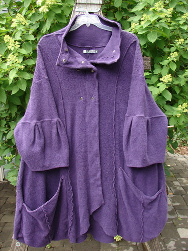 Barclay Patched Celtic Moss Double Snap Button Back Coat in Violet, featuring wide bell sleeves, asymmetrical front, high collar with snap closures, and roomy pockets, exemplifying Bluefishfinder.com's vintage creative style.