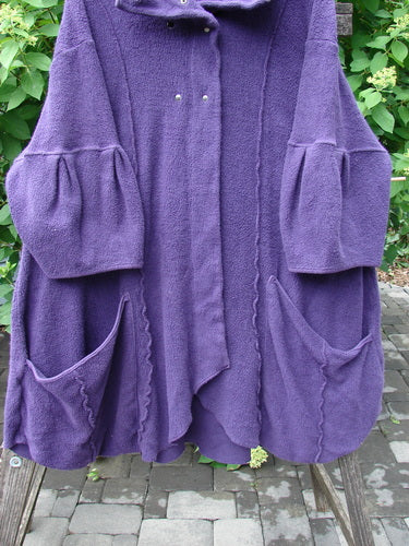 Barclay Patched Celtic Moss Double Snap Button Back Coat Violet OSFA, featuring a flared silhouette, high collar, puffed sleeves, and large front pockets, crafted from plush, dense fabric, hanging outdoors.