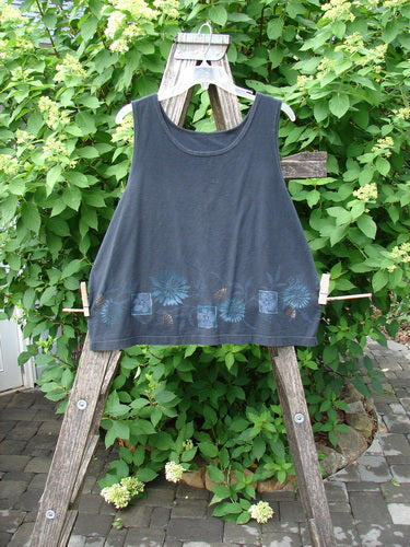Barclay Cotton Lycra Tank Border Garden Black Size 2, elegantly displayed on a wooden ladder outdoors, with a leafy shrub in the background, reflecting BlueFishFinder's vintage, individualistic style.