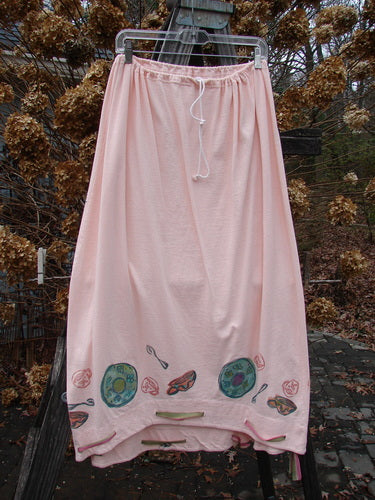 1992 Buttonloop Skirt Breakfast Diner Sea Shell OSFA: A pink skirt with hand-painted diner-themed designs, featuring a drawcord waist, varying hemline, and buttonholes with silk ribbon accents.