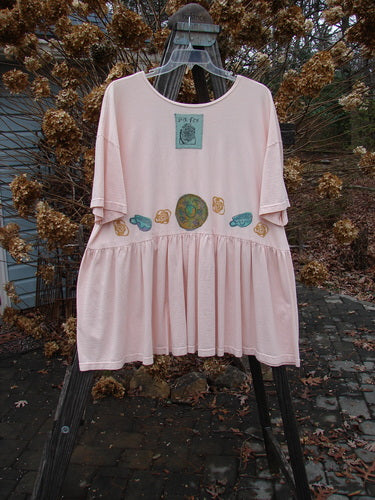 1992 Studio Cardigan Dress Breakfast Diner Sea Shell OSFA displayed on a hanger, featuring a flouncy front, gathered waistline, vintage buttons, and a whimsical breakfast diner theme with a distinctive blue patch.