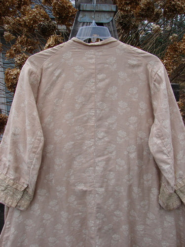 A close-up of a Magnolia Pearl European Cotton Snap A Line Cardigan Floral Mix OSFA shirt with 1 front spot and 3 sleeve spots.
