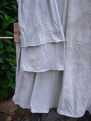 Barclay Cotton Lycra Petal Sleeved A Line Tunic Floral Dawn Flawed Birch Bark Size 1 features a rounded neckline, generous A-line shape, and double petal sleeves with visible blue dye transfer.