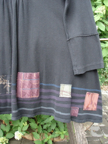 Barclay Patched Thermal Single Button Cardigan Tiny Square Black Size 0 features a long-sleeved design with decorative muted square patches, a single wooden button, and a wide V-neck, hanging outdoors against leafy shrubs.