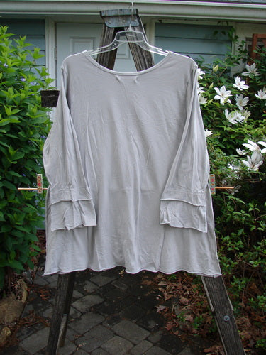 Barclay Cotton Lycra Petal Sleeved A Line Tunic Floral Dawn Flawed Birch Bark Size 1, showcasing thick double petal sleeves and a rounded neckline, features a blue dye transfer flaw on one sleeve.