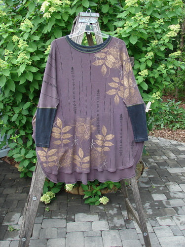 Barclay Thermal Contrast Revival Top draped on a wooden ladder, featuring a metallic leaf pattern, ribbed sleeves, and neckline, capturing Bluefishfinder.com's vintage style.