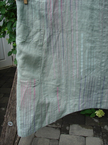 Barclay Linen Side Pocket Apron Jumper Verticals Sage Size 0 features a sage linen with pastel vertical stripes, a banded upper bib, adjustable shoulder straps, and two wrap drop side pockets, hanging outdoors.