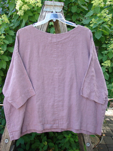 Barclay Linen Lantern Boxy Top in unpainted dark mauve, size 1, with a square boxy shape and drop shoulders, showcased on a wooden ladder, reflecting BlueFishFinder's vintage, creative style.