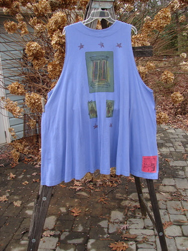 1997 Simple Vest Lamp Chair Skylark Size 2: Swing-style blue shirt with graphic design, deep side pockets, and oversized knotted buttons.
