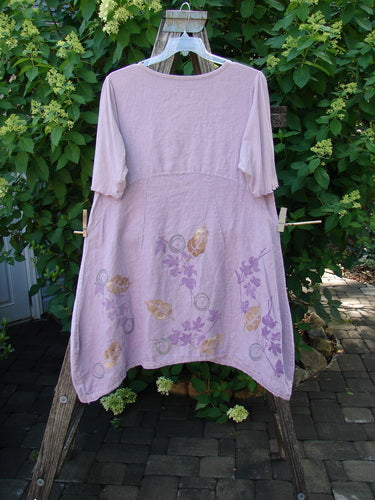 Barclay Linen Lace Blooming Tunic Dress Leaf Vine Lavender Size 0 displayed outdoors, featuring elbow-length sleeves, botanical motifs, a crossover neckline, and lace-trimmed hem, embodying artistic and vintage expression.