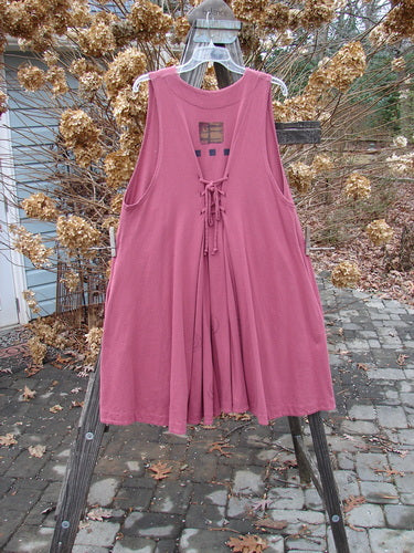 1997 Fresco Vest Structure Fascia OSFA displayed on a rack, featuring deep side pockets, oversized buttons, and an adjustable lace, highlighting its wide swingy A-line shape and unique hemline.