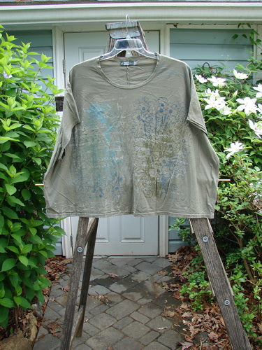 Barclay Cricket Cap Sleeve Tee Script Garden Bottlecap OSFA, featuring cap sleeves, a slight hip flare, rounded hemline, and seamless shoulder sleeves, embodying BlueFishFinder's unique vintage style and creativity in organic cotton.