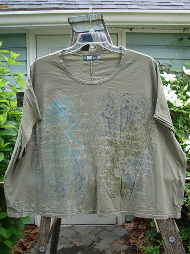 Barclay Cricket Cap Sleeve Tee Script Garden Bottlecap OSFA features cool cap sleeves, a square boxy shape, and a rounded hemline, embodying effortless style in lightweight organic cotton.