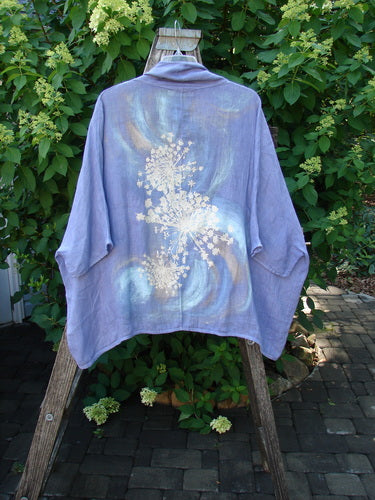 Barclay Linen Open Front Cheerful Cardigan Jacket Rear Starburst Iris Size 1 displayed outdoors on wooden support, showcasing a hand-painted white floral motif on its back, embodying Blue Fish's creative, vintage aesthetic.