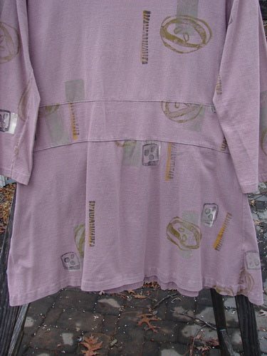 1991 Workshop Dress Spin Stone Currant OSFA featuring a face print, long sleeves, drop waistband, double pleats, and pin tucking for a tailored fit.