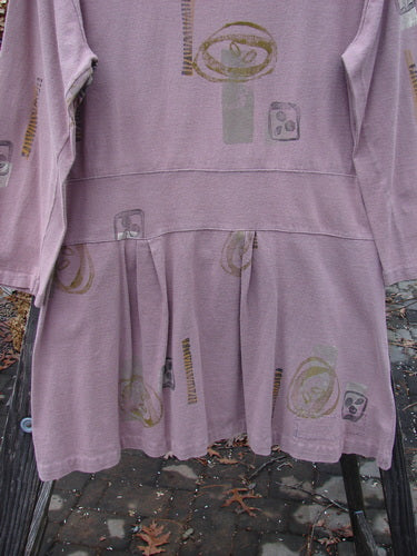 1991 Workshop Dress Spin Stone Currant OSFA, featuring a pink pattern, long sleeves, drop waistband, double pleats, and a scooped neckline, made from medium-weight cotton for a tailored fit.