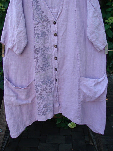 Barclay Linen Double Tie Back Jacket Single Garden Row Pink Cloud Size 1, featuring a loose fit, button front, mid-length sleeves, large patch pockets, and floral print panel on lavender fabric.