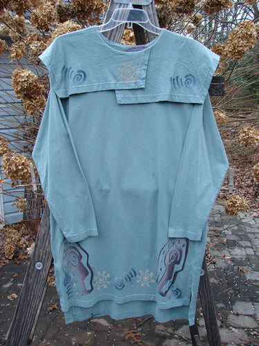 1996 Trifocal Top Celestial Trinket Size 1 featuring a rear shirttail hemline, vented sides, and an abstract forest theme design, displayed hanging on a clothes rack.