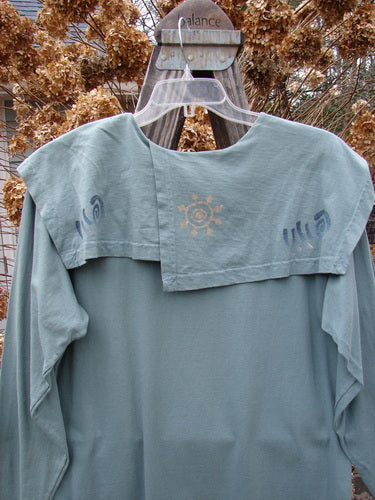 1996 Trifocal Top Celestial Trinket Size 1 displayed on hanger, featuring a unique folded collar, rear shirttail hemline, and abstract forest-themed design.