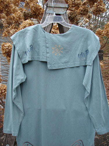 1996 Trifocal Top Celestial Trinket Size 1 displayed on a swinger outdoors, showcasing its unique folded sectional collar, rear shirttail hemline, and abstract forest-themed paint with a Blue Fish patch.
