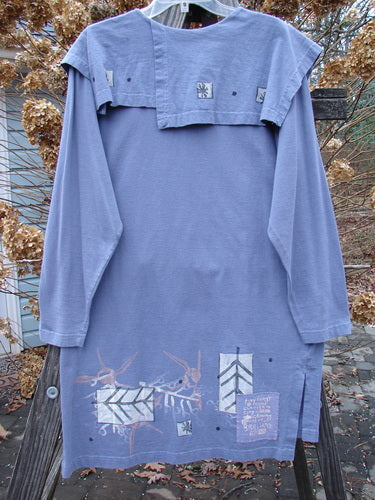 1996 Trifocal Top with abstract arrow design, made from organic cotton. Straight shape, rear shirttail hemline, vented sides, folded sectional collar front and back. Signature blue fish patch on lower hem. Size 1.