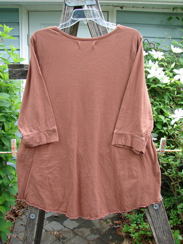 Barclay Banded Artist Pocket Top Sunflower Rust Size 1, featuring a rounded neckline, three-quarter banded sleeves, double diagonal pockets, and a sunflower motif, embodying vintage Blue Fish Clothing’s creative freedom.