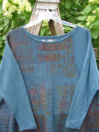 Barclay Thermal Monte Verde Vented Tunic Grid Blend Tealen OSFA draped on a ladder, showcasing its abstract pattern and vented design, highlighting the creative vintage style offered by Bluefishfinder.com.
