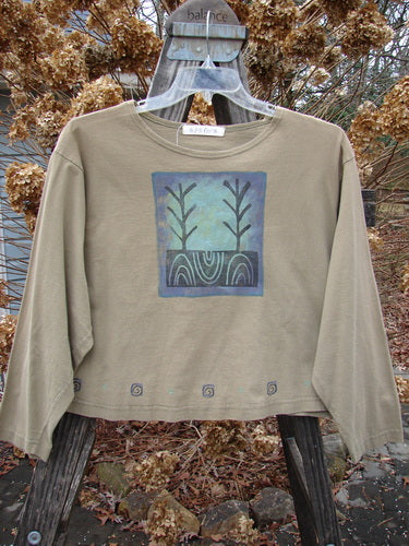1996 Boxy Tee Top Twig Tree Bottlecap Size 2 displayed on a hanger, showcasing long sleeves, a slightly wider neckline, vented sides, gently rolled edges, and a continuous twig tree pattern.