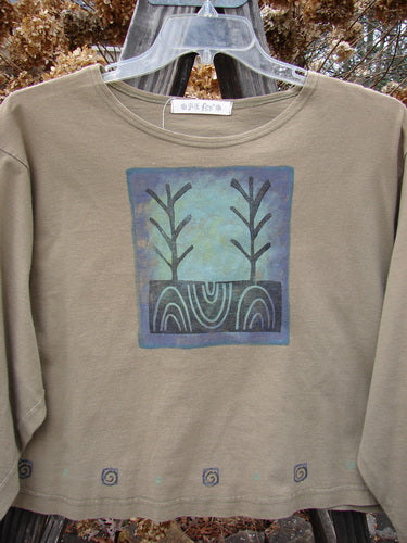 1996 Boxy Tee Top Twig Tree Bottlecap Size 2 featuring a tan shirt with a blue square and tree pattern, slightly wider neckline, vented sides, and a gently rolled neckline.