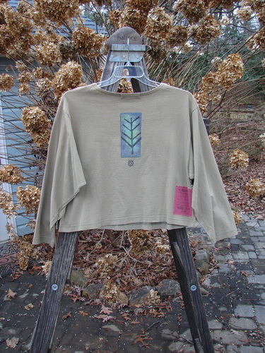 1996 Boxy Tee Top Twig Tree Bottlecap Size 2 displayed on a swinger, showcasing its slight A-line crop shape, gently rolled neckline, and continuous twig tree theme paint.
