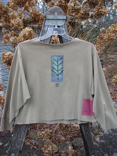 1996 Boxy Tee Top Twig Tree Bottlecap Size 2 displayed on a hanger, showcasing its long sleeves, slightly wider neckline, and twig tree theme paint with a Blue Fish patch.