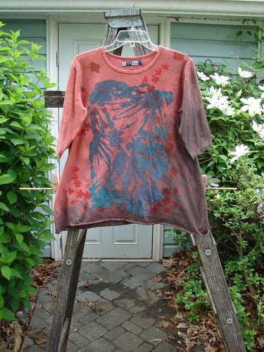 Barclay Three Quarter Sleeved Cafe Tee in Mottled Burnt Orange, displaying a flowing A-line silhouette with rolled neckline and curly edges, embodies Bluefishfinder's vintage, creative spirit. Size 0, 26-inch length.