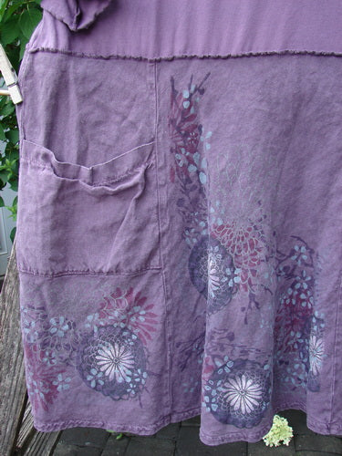 Barclay Linen Cotton Two Pocket Tie Back Square Dress Bloom Burst Plum Size 1, featuring a lightweight fabric, patch pocket, and a subtle floral print, hanging outdoors, embodying BlueFishFinder's vintage, expressive style.
