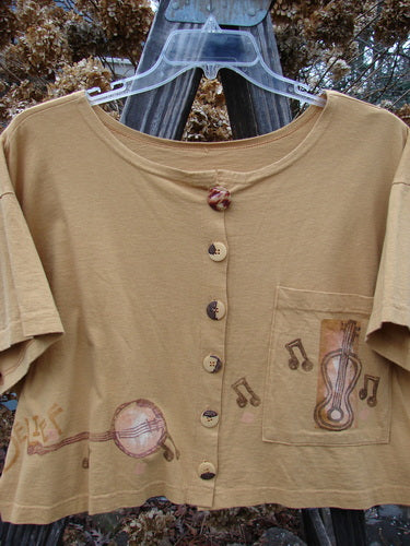 1994 Song Top Make Music Dijon Size 2: A brown mid-weight cotton shirt with a wide crop box shape, painted music theme, oversized front pocket, and matching oversized buttons.