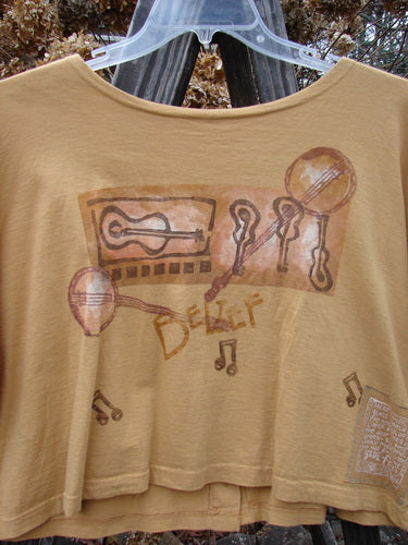1994 Song Top Make Music Dijon Size 2: T-shirt with musical instruments illustration, wide crop box shape, oversized front painted breast pocket, and unique buttons, capturing vintage Blue Fish Clothing's creative essence.