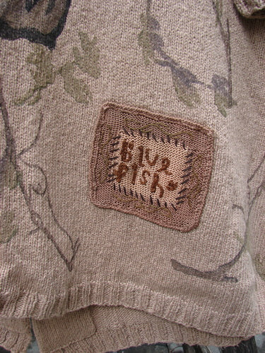 Close-up of the 1998 Cotton Knit Canyon Cardigan Sweater Coat Pear Harvest Aspen OSFA, featuring a luv2fish patch, intricate leafy patterns, ribbed accents, and an oversized clay button.