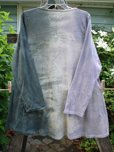 Barclay Long Sleeved A Lined Tunic Petals Mottled Lavender Size 0, showcasing a sweeping A-line shape, rounded neckline, long sleeves, and giant spring floral theme, crafted from medium-weight organic cotton.