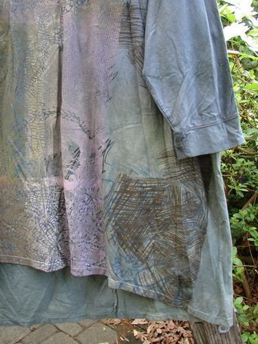 Barclay Banded Oversized Art Top in mottled grey, showcasing a tight floral grid pattern. Features include a rounded neckline, drop shoulders, and a varying hemline, perfect for creative individual expression.