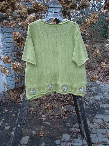 1999 Spring Pullover Tunic Sweater Kiwi Size 2 displayed on a rack, featuring varied vertical textures, drop shoulders, and a rolled neckline.