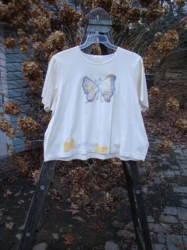 1999 Light Weight Short Sleeved Crop Tee Butterfly Natural Size 2 with butterfly design on front, rounded neckline, boxy shape, and vintage Blue Fish patch, made from soft organic cotton.