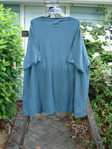 Barclay Art Tunic Stone Garden in Mottled Green Mineral OSFA features a tunic length, drop shoulders, three-quarter sleeves, rounded neckline, and unique hemline with a Victorian gate theme paint.