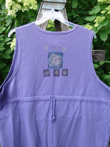 1996 Symbol Vest Star Rain Byzantium Size 2 displayed outdoors. A sleeveless, hooded design with geometric patterns, chunky buttons, and rear drawcord in heavy-weight organic cotton, emphasizing unique vintage style from Bluefishfinder.com.