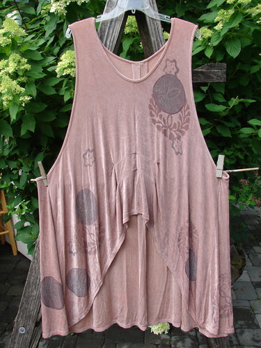 1999 Acetate Lycra Rosewater Sleeveless Pullover Circle Flower Rosetta OSFA with asymmetrical hem, deep side pockets, and stencil-style circle and floral motifs, displayed on a clear hanger against green foliage.