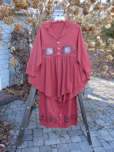 1997 Hearth Peplum Button Duo Vines Brick Size 2 displayed on a wooden rack, showcasing the jacket's deep V neckline, oversized buttons, and peplum hem, paired with the matching button skirt.