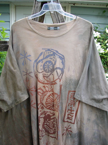 Barclay Art Top Blue Fish Sign Mottled Stick OSFA features a tunic length, drop shoulders, three-quarter sleeves, rounded neckline, varying hemline, and vintage Blue Fish logo, emphasizing individuality and creativity.