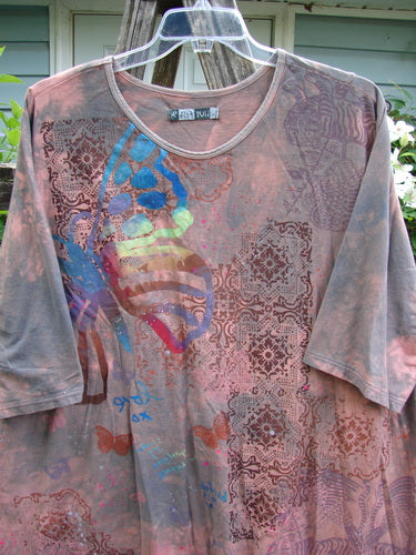 Barclay Tournesol Tunic Butterfly Love Mottled Sunset OSFA features a loose, tunic-length design with drop shoulders, three-quarter sleeves, and a rounded neckline, showcasing the Butterfly Blue Fish Love theme.