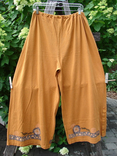 1994 Banjo Pant Dandelion Breeze Oro Size 2 features wide-leg mustard-yellow pants with an elastic waistband, decorative floral border, fabric buttons on the cuff, ideal for expressing vintage style.